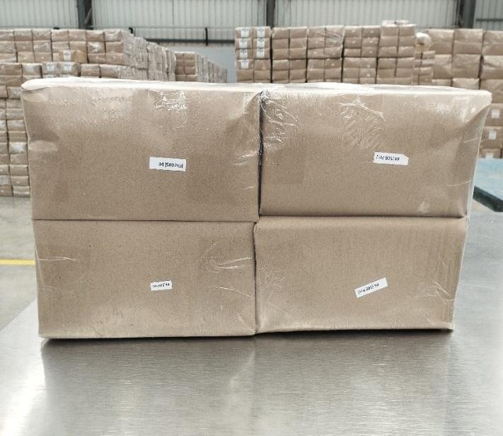 Kraft-wrapped, labelled bundles of SOS bags stacked four to a block in the finished goods area