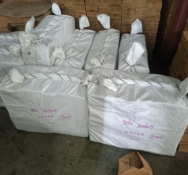 Woven polypropylene sacks of paper bags tied and marked with customer name and size