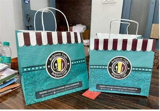Two teal multicolour handle bags printed for Belgium Café