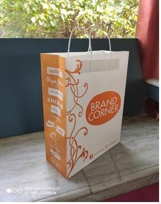 Kraft handle bag printed in orange for Brand Corner