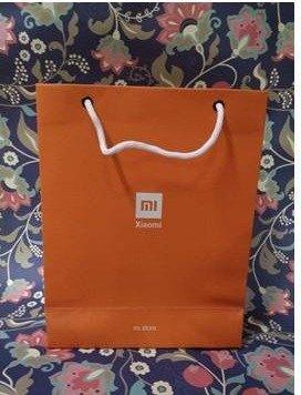 Orange premium bag with white rope handles and the Xiaomi mark